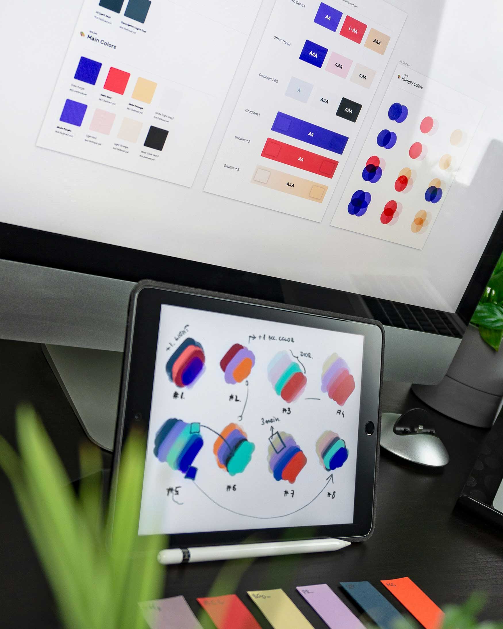 A photo of an iPad and iMac showcasing various color schemes used for branding.