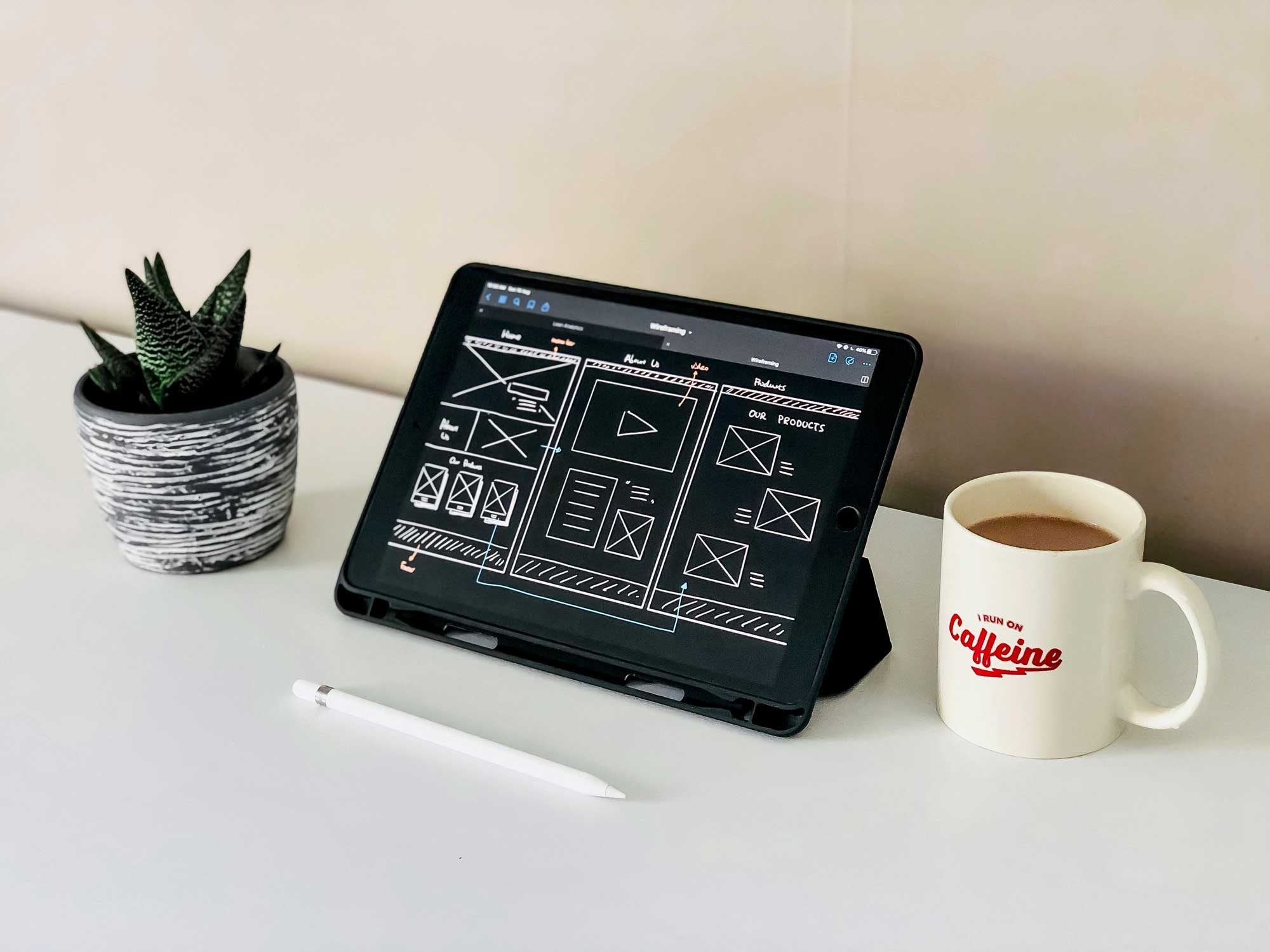 A photo of an iPad with a website wireframe drawn on it.
